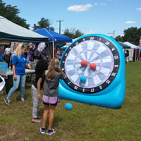 Kids playing inflated dart game